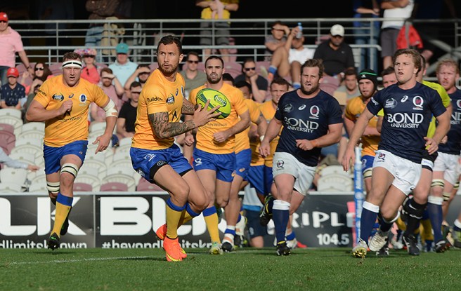 Quade Cooper, ball in hand during the NRC's Queensland derby.  Sourced from:  www.greenandgoldrugby.com